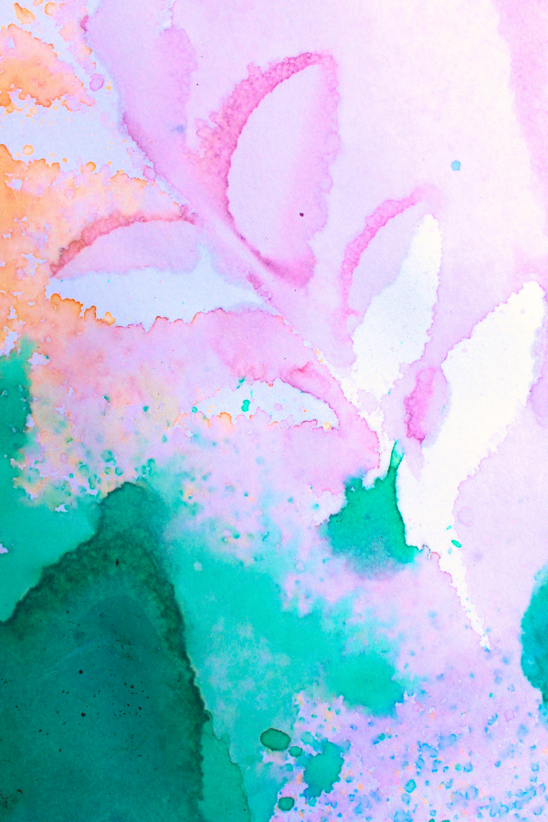 A colorful paper splattered with bright shades of orange, pink and blue around bright white leaf shapes.