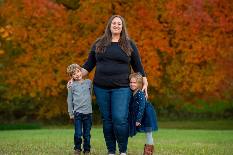 Author Pic A woman with brown hair and 2 kids smiling.